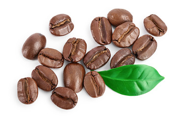 Heap of roasted coffee beans with leaves isolated on white background with clipping path and full depth of field . Top view. Flat lay.