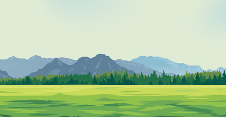 green glade against the background of mountains