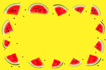 Fresh tasty slices of ripe red watermelon with pits isolated on yellow background. Blank, mock up, copy space, place for text. Summer, fruits, vacation concept. Flat lay, top view. Watermelon pattern.