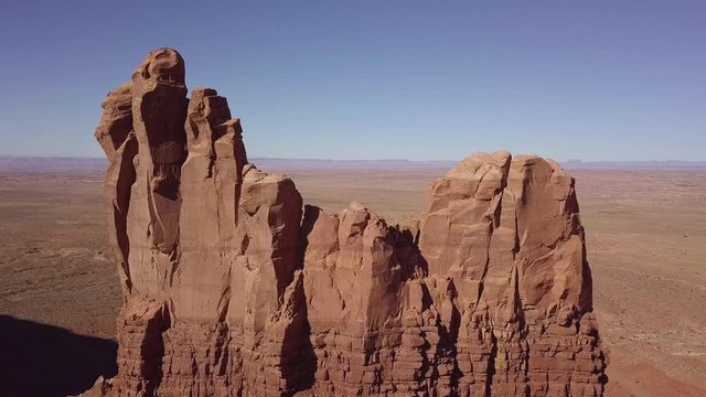 Raw drone low pass video of the Setting Hen rock formation in Monument Valley