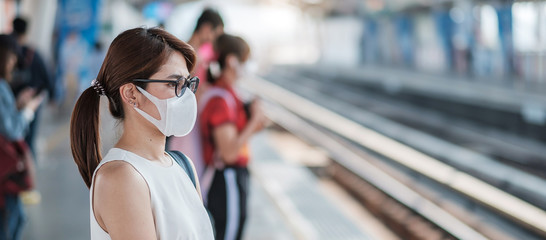 young Asian woman wearing protection mask against Novel coronavirus (2019-nCoV) or Wuhan...
