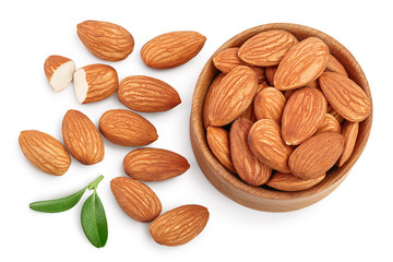 Almonds nuts with leaves in wooden bowl isolated on white background with clipping path and full depth of field. Top view. Flat lay