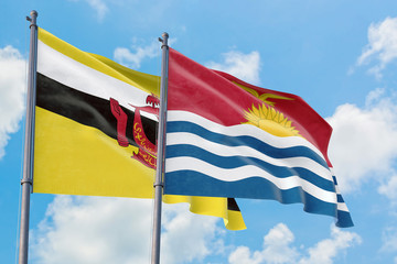 Kiribati and Brunei flags waving in the wind against white cloudy blue sky together. Diplomacy concept, international relations.