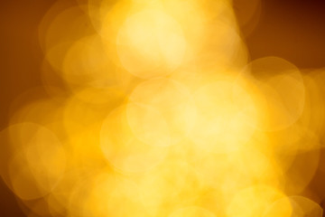 Golden bokeh surface of the dark glittering background
