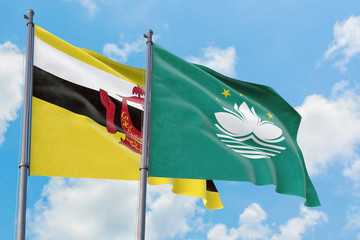 Macao and Brunei flags waving in the wind against white cloudy blue sky together. Diplomacy concept, international relations.