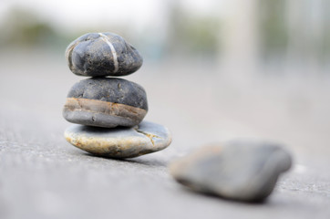 Pebbles stacked in front of a hazy background