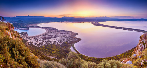 Amazing sunrise view with multicolored clouds from Navarino Castle. Romantic sunset on Voidokilia...