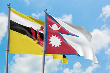 Nepal and Brunei flags waving in the wind against white cloudy blue sky together. Diplomacy concept, international relations.