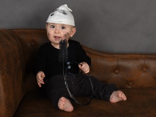 portrait of a little boy in a chimney-sweep costume