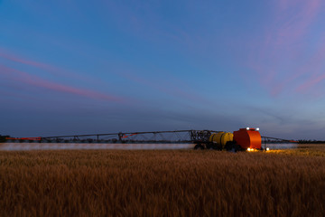 Autonomous machine for spraying pesticides and herbicides in the field at work. Smart farming