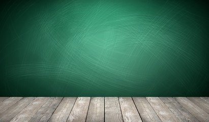 Rubbed out chalk on a greenboard, wooden floor