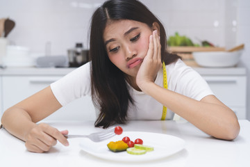 Obraz na płótnie Canvas Asian woman eat disorder during diet.