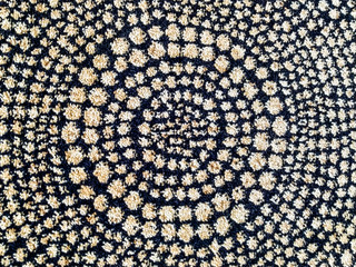 Abstract design of woolen carpet rug with warm, fluffy and soft texture with dots making concentric circles for modern and interesting flooring