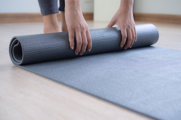 Healthy and wellness lifestyles concept. Woman prepare yoga mat to meditation.