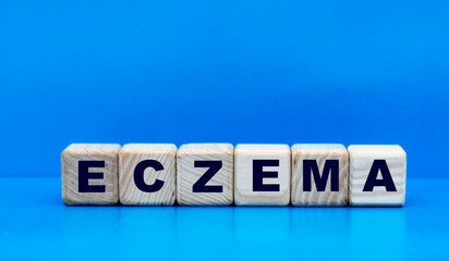 concept word eczema on cubes on a blue background