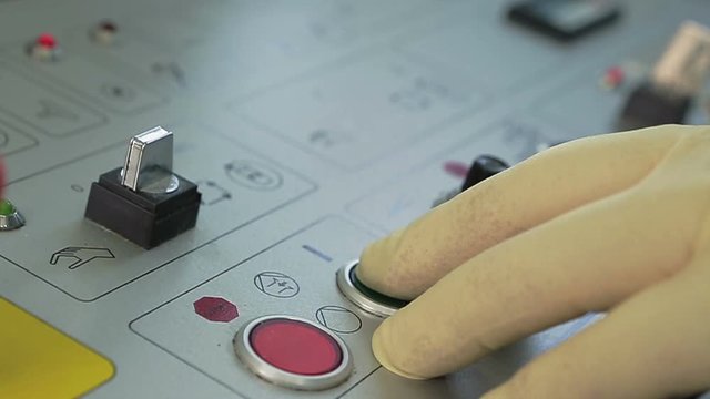 Finger presses red and green button on the remote control production