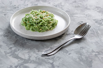 Green pasta with avocado, spinach and pine nuts