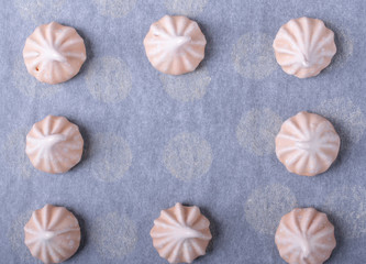 Meringues on the used baking parchment paper. Cooking background. Copy space