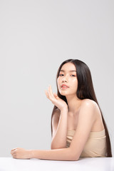 Naklejka premium Beautiful Asian young woman touching soft cheek smile with clean and fresh skin Happiness and cheerful with positive emotional,isolated on white background,Beauty and Cosmetics Concept