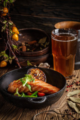 European cuisine in Ukrainian style. A large steak of red salmon fish, with mushrooms, asparagus, cherry tomatoes and fried lemon. Serving meals in a rustic restaurant.