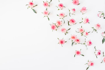 Floral composition with pink rose flower buds and leaves pattern on white background. Flatlay, top view.