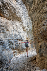Hiker in a narrow trail of Imbros gorge, Crete, Greece