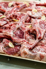 Raw Meat Marinated Lamb Chops on Tray / Marinating Before Cooking.
