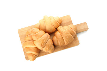 Cutting board with croissants isolated on white background