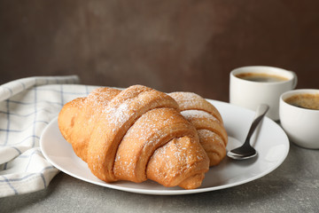 Composition with tasty croissants on grey table, close up