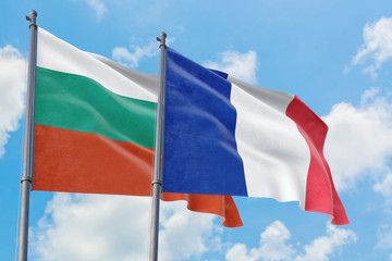 France and Bulgaria flags waving in the wind against white cloudy blue sky together. Diplomacy concept, international relations.