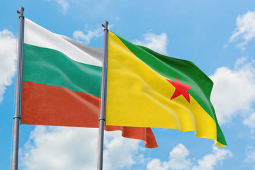 French Guiana and Bulgaria flags waving in the wind against white cloudy blue sky together. Diplomacy concept, international relations.
