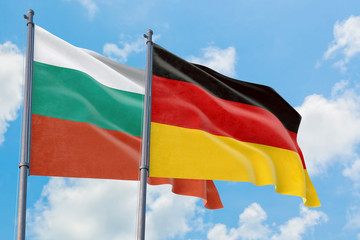 Germany and Bulgaria flags waving in the wind against white cloudy blue sky together. Diplomacy concept, international relations.