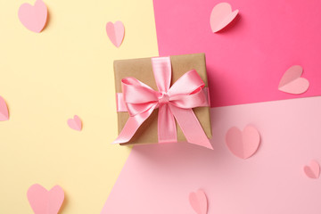 Gift box on multicolored background, top view