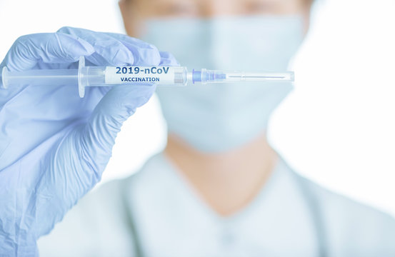 Medical scientist holding syringe with vaccination 2019-nCoV Coronavirus.