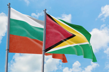 Guyana and Bulgaria flags waving in the wind against white cloudy blue sky together. Diplomacy concept, international relations.