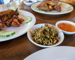 Selection of burmese dishes in rural Myanmar with skinny chicken and traditional soup