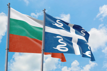 Martinique and Bulgaria flags waving in the wind against white cloudy blue sky together. Diplomacy concept, international relations.