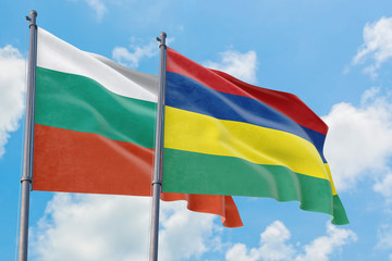 Mauritius and Bulgaria flags waving in the wind against white cloudy blue sky together. Diplomacy concept, international relations.