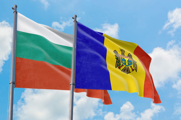 Moldova and Bulgaria flags waving in the wind against white cloudy blue sky together. Diplomacy concept, international relations.