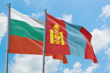 Mongolia and Bulgaria flags waving in the wind against white cloudy blue sky together. Diplomacy concept, international relations.