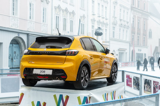 Wels, Austria - January 12th, 2020: Newest Peugeot 208 gt-line 2020 model stand on basement among public skating rink in center old european city Wels. Vehicle advertisment and presentation in Europe