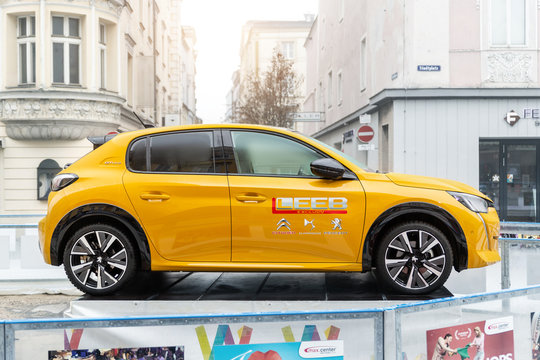 Wels, Austria - January 12th, 2020: Newest Peugeot 208 gt-line 2020 model stand on basement among public skating rink in center old european city Wels. Vehicle advertisment and presentation in Europe