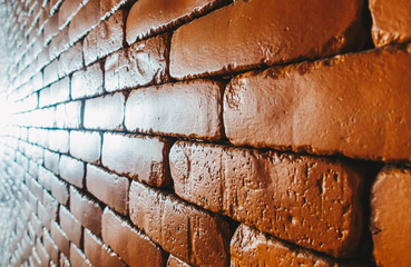 Close up Orange brick wall with light in horizontal perspective view for concept design background wallpaper