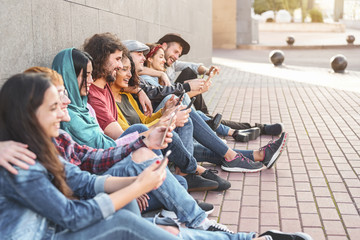 Group trendy friends using smart mobile phones outdoor - Millennial people having fun with new...
