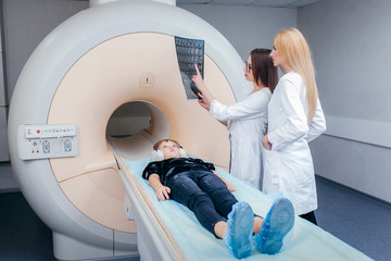 Two young female doctors checking a mri picture - obrazy, fototapety, plakaty