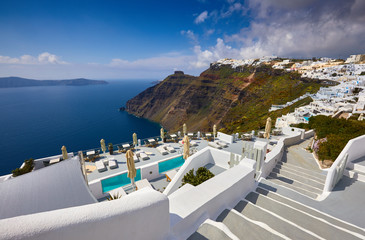 Fira town on Santorini island, Greece. Incredibly romantic sunrise on Santorini. Oia village in the sun light. Amazing sunset view with white houses. Island of lovers