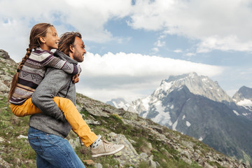 Fototapeta na wymiar Father with child walking on the mountain and enjoying beautiful view