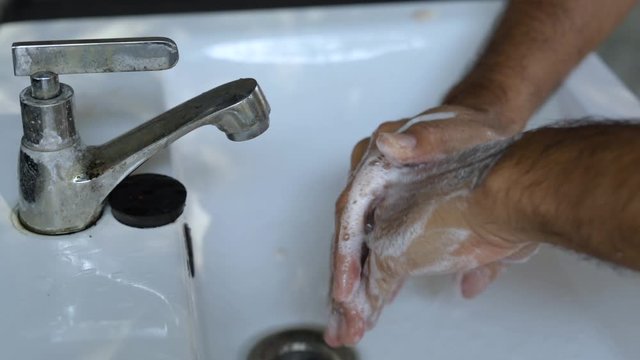 Hygiene concept, man washes his hands with soap 