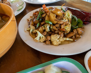 Selection of burmese dishes in rural Myanmar with skinny chicken and traditional soup