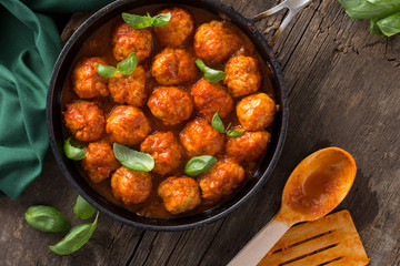Traditional italian Meatballs served on a old wooden table. Meatballs served on a old wooden table with green napkin and spoon. Homemade delicious italian Meatballs on on a rustic table for dinner. it